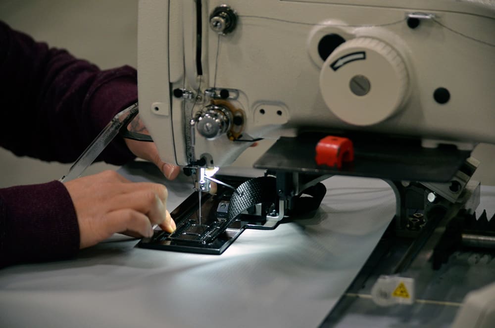 Mattress cover features being sewn by a skilled Alpha Tekniko employee.